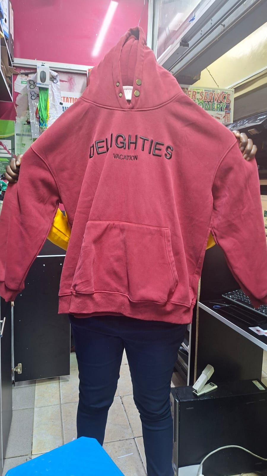 Our red hoodie with embroidered lettering